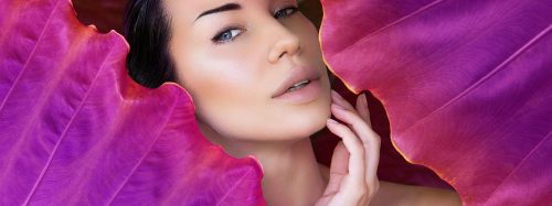 Young,Woman's,Face,Surrounded,By,Colored,Tropical,Leaves.,Woman,Face